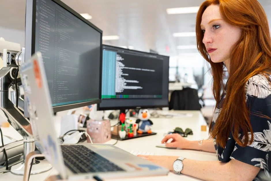 A modern computer screen displaying web design work, showcasing creative visuals in a workspace.
